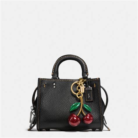 coach purse with cherry charm